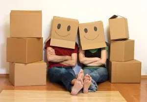 Happy couple in their new home having fun - moving concept