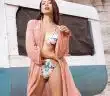 Sensual young female traveler in bikini relaxing in desert valley