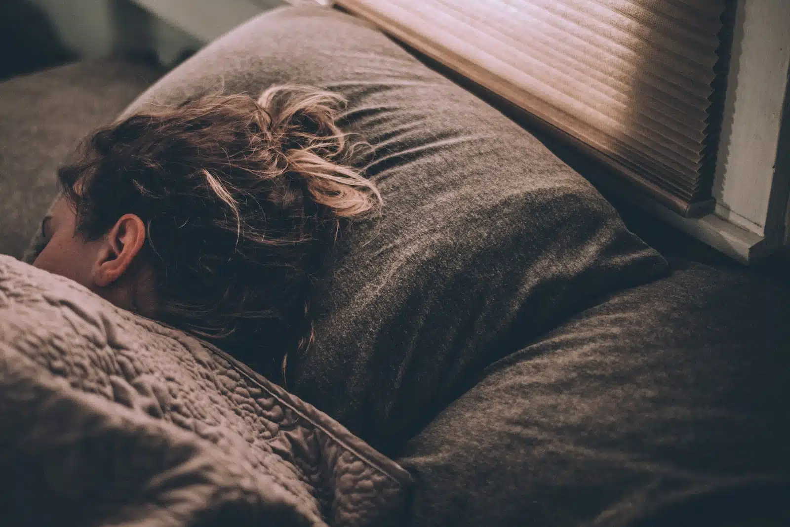 Une femme dort dans son lit