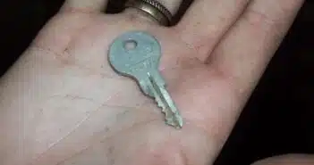 gray key in person's palm