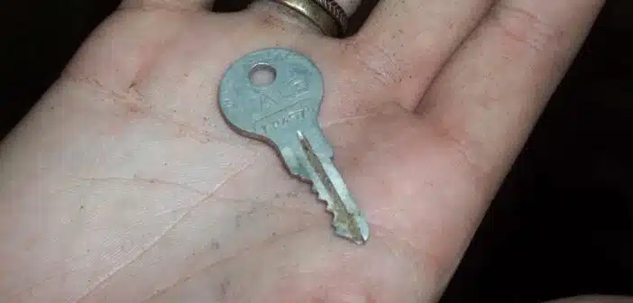gray key in person's palm